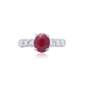 Oval Ruby and Bezel Set Round Diamond Ring